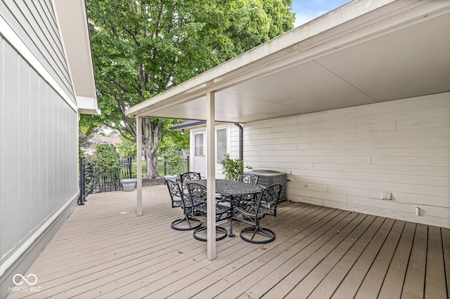 12388 Camberley Ln, Carmel, IN 46033 - wooden terrace with outdoor dining space and cooling unit