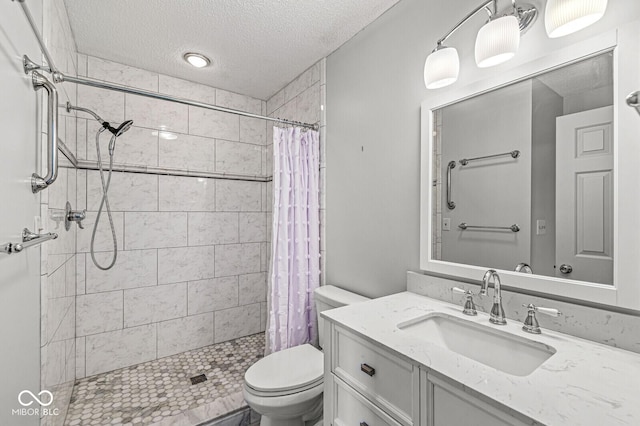 12388 Camberley Ln, Carmel, IN 46033 - bathroom featuring toilet, a textured ceiling, a shower stall, and vanity