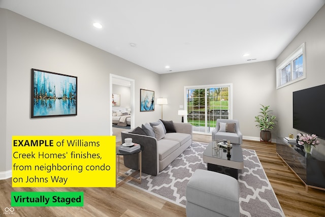 3354 Johns Way, Greenwood, IN 46143 - living area featuring wood finished floors, healthy amount of natural light, recessed lighting, and baseboards