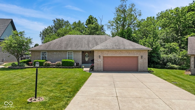 205 Canaan Ct, Mooresville, IN 46158 - view of front of property with a front lawn, a garage, brick siding, a shingled roof, and concrete driveway