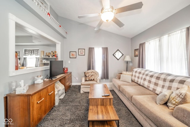 carpeted living room featuring vaulted ceiling, ceiling fan, and baseboards