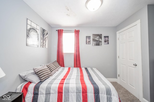 carpeted bedroom with baseboards