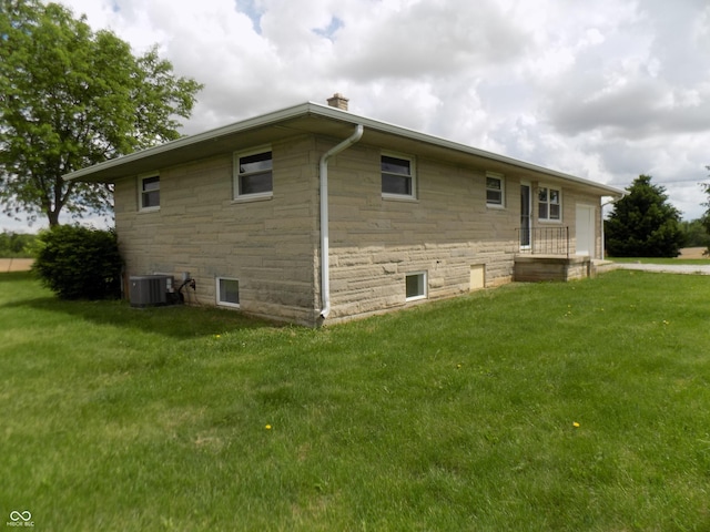 9739 S County Road 825 E, Cloverdale, IN 46120 - view of property exterior featuring stone siding, a lawn, and cooling unit