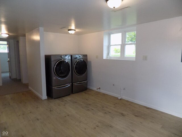 9739 S County Road 825 E, Cloverdale, IN 46120 - laundry area with washer and clothes dryer, light wood-style flooring, baseboards, and plenty of natural light