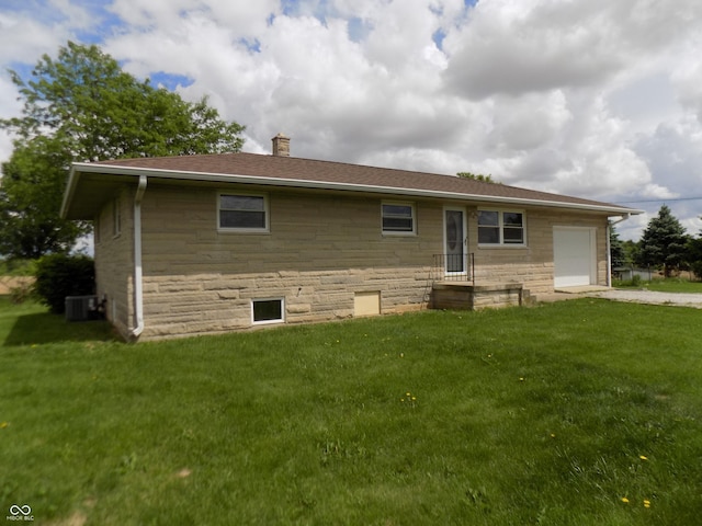9739 S County Road 825 E, Cloverdale, IN 46120 - rear view of house featuring a chimney, an attached garage, stone siding, and a lawn