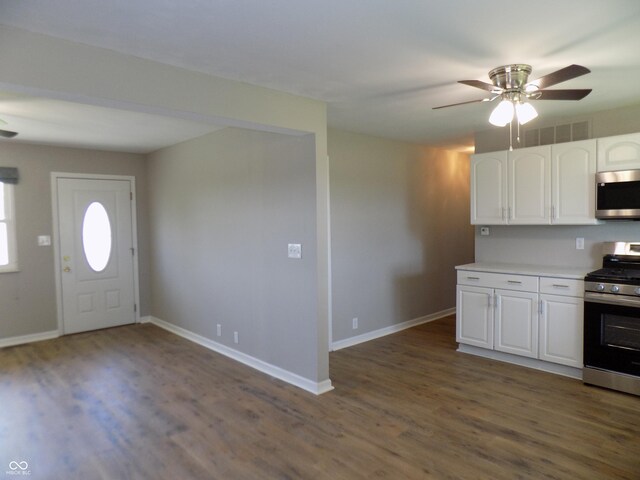 9739 S County Road 825 E, Cloverdale, IN 46120 - kitchen featuring stainless steel appliances, dark wood-style floors, white cabinets, ceiling fan, and baseboards