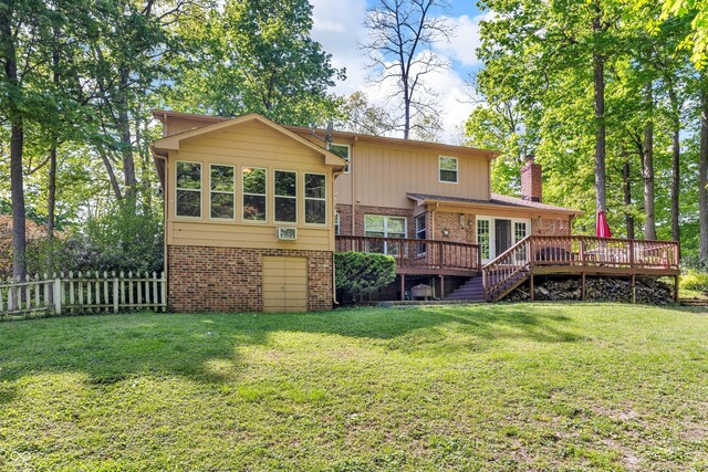 610 N Forest Rd, Crawfordsville, IN 47933 - rear view of property with brick siding, a wooden deck, a chimney, an attached garage, and stairway