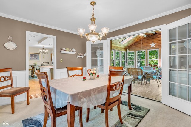 610 N Forest Rd, Crawfordsville, IN 47933 - dining area with a chandelier, light carpet, vaulted ceiling, ornamental molding, and a wainscoted wall
