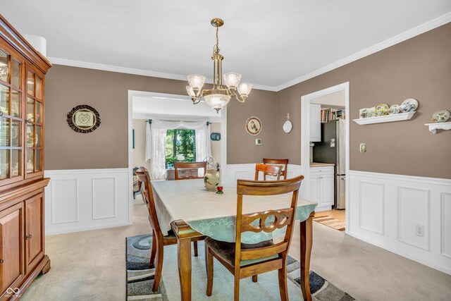 610 N Forest Rd, Crawfordsville, IN 47933 - dining area with light carpet, ornamental molding, wainscoting, a chandelier, and a decorative wall