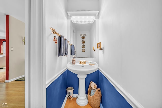 610 N Forest Rd, Crawfordsville, IN 47933 - bathroom featuring wood finished floors, baseboards, and a sink