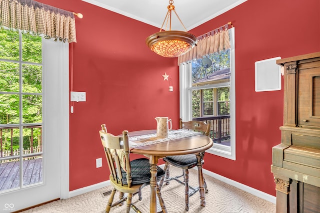610 N Forest Rd, Crawfordsville, IN 47933 - carpeted dining space with baseboards, plenty of natural light, and ornamental molding