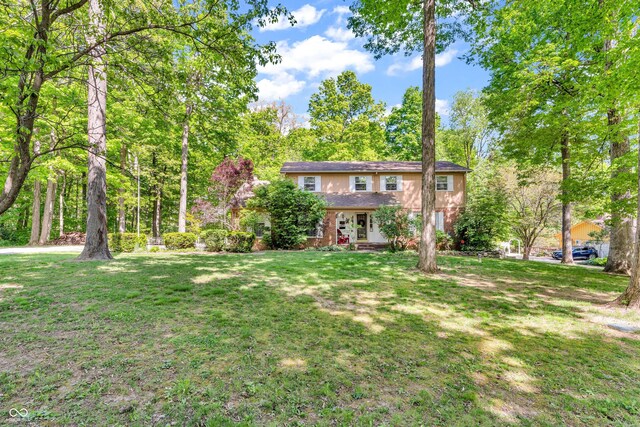 610 N Forest Rd, Crawfordsville, IN 47933 - back of house featuring a yard and brick siding