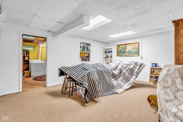 610 N Forest Rd, Crawfordsville, IN 47933 - carpeted bedroom with a drop ceiling, washer and clothes dryer, concrete block wall, baseboards, and ensuite bath