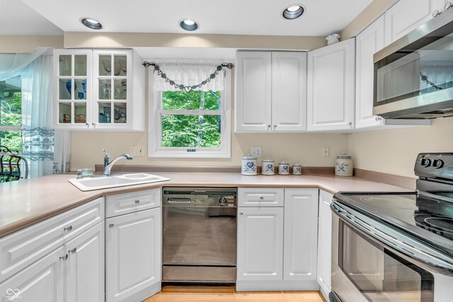610 N Forest Rd, Crawfordsville, IN 47933 - kitchen featuring stainless steel appliances, a sink, white cabinets, light countertops, and recessed lighting