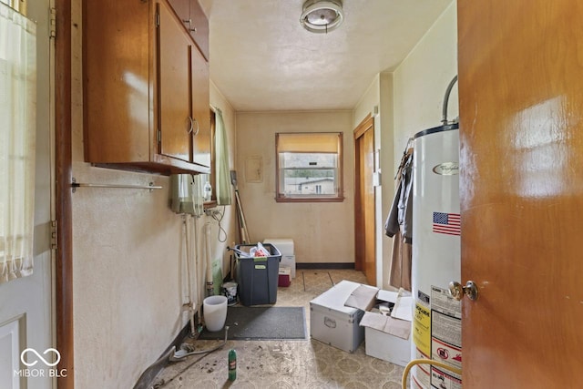 2840 W 12th St, Anderson, IN 46011 - clothes washing area featuring gas water heater and baseboards