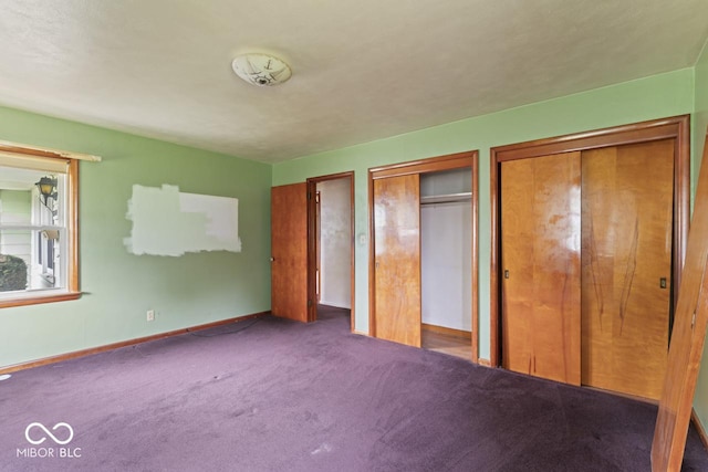 2840 W 12th St, Anderson, IN 46011 - unfurnished bedroom with two closets, carpet floors, and baseboards