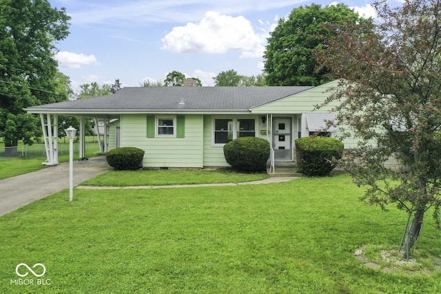 2840 W 12th St, Anderson, IN 46011 - view of front facade with driveway, a chimney, a front yard, and a carport