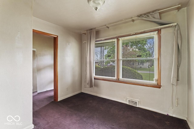 2840 W 12th St, Anderson, IN 46011 - spare room featuring dark carpet and baseboards