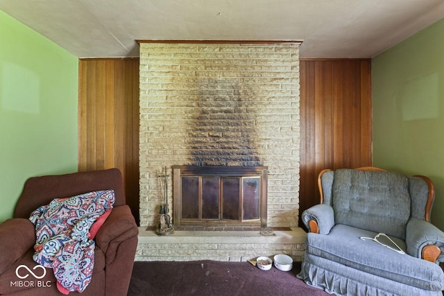 2840 W 12th St, Anderson, IN 46011 - sitting room featuring a brick fireplace, carpet floors, and wooden walls