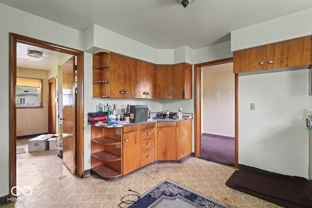 2840 W 12th St, Anderson, IN 46011 - kitchen with open shelves, brown cabinetry, and light floors