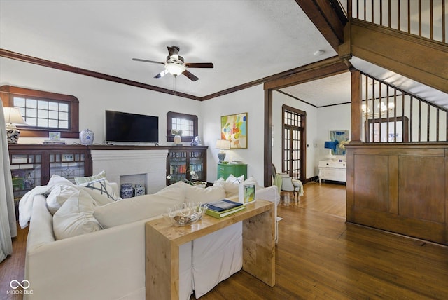 1132 Evison St, Indianapolis, IN 46203 - living area featuring ceiling fan, ornamental molding, dark wood-type flooring, a fireplace, and baseboards
