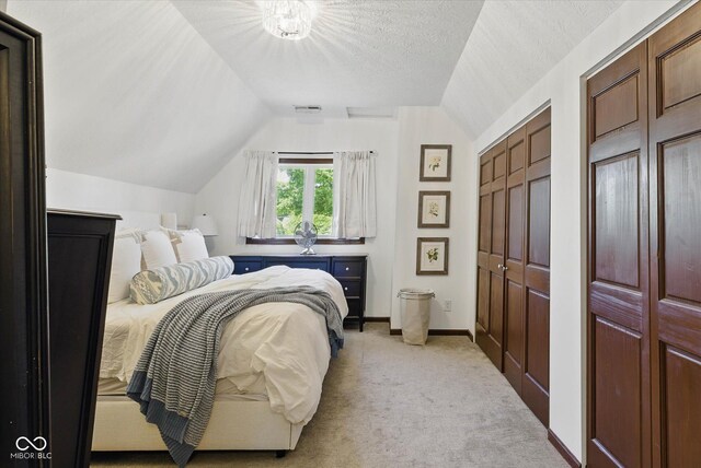 1132 Evison St, Indianapolis, IN 46203 - bedroom featuring vaulted ceiling, light carpet, baseboards, and multiple closets