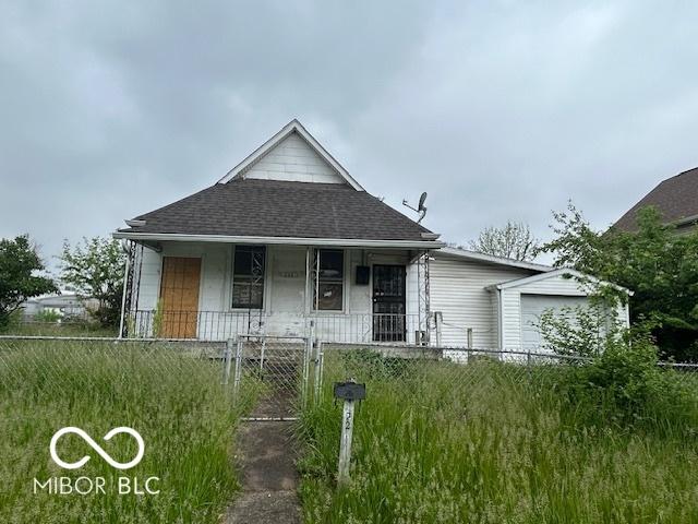 226 Miley Ave, Indianapolis, IN 46222 - bungalow with a porch, roof with shingles, a fenced front yard, and a gate