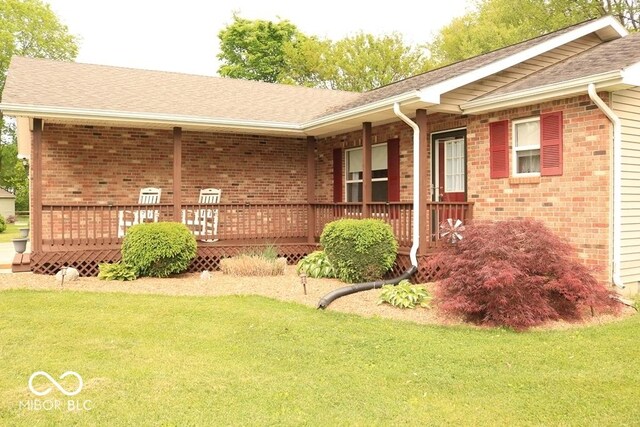 7 Gladiator Dr, Waynetown, IN 47990 - view of front of house featuring brick siding, a front yard, and a shingled roof