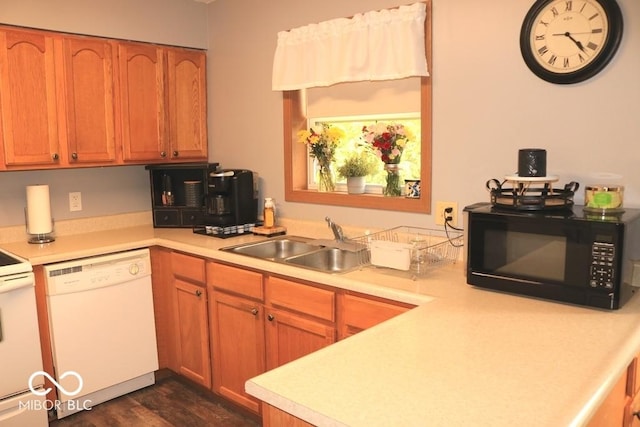 7 Gladiator Dr, Waynetown, IN 47990 - kitchen featuring white appliances, light countertops, a sink, dark wood-style flooring, and brown cabinetry