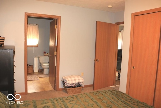 7 Gladiator Dr, Waynetown, IN 47990 - bedroom featuring connected bathroom, baseboards, and a closet