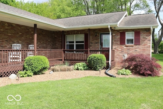 7 Gladiator Dr, Waynetown, IN 47990 - ranch-style house with roof with shingles, a front yard, brick siding, and a porch