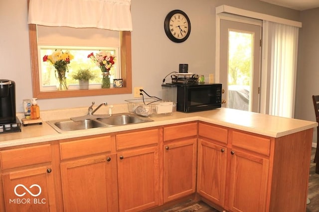 7 Gladiator Dr, Waynetown, IN 47990 - kitchen featuring black microwave, a sink, light countertops, and a peninsula