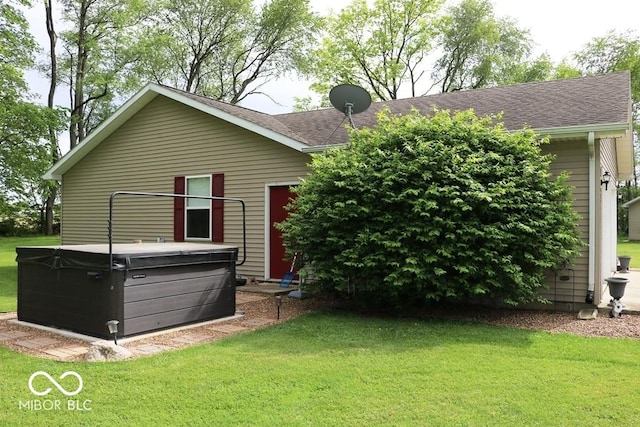 7 Gladiator Dr, Waynetown, IN 47990 - back of property featuring a hot tub, a lawn, and a shingled roof