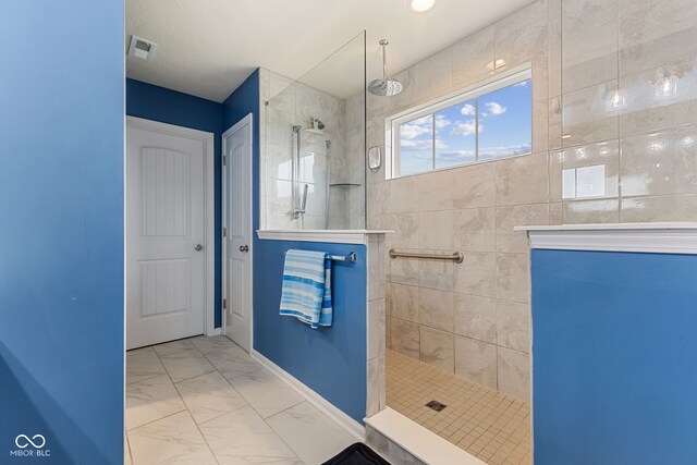 3948 Saddle Club S Parkway, Bargersville, IN 46106 - bathroom with walk in shower, marble look tile flooring, and baseboards