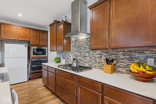 3948 Saddle Club S Parkway, Bargersville, IN 46106 - kitchen with appliances with stainless steel finishes, exhaust hood, tasteful backsplash, light countertops, and light wood-style floors