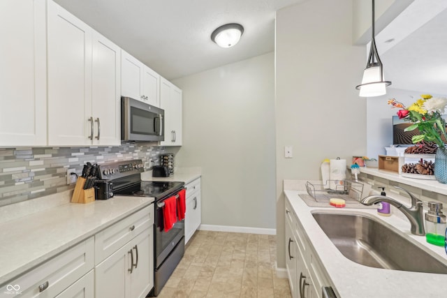 8910 Hunters Creek Dr Unit 207, Indianapolis, IN 46227 - kitchen with stainless steel microwave, range with electric stovetop, a sink, tasteful backsplash, and white cabinets