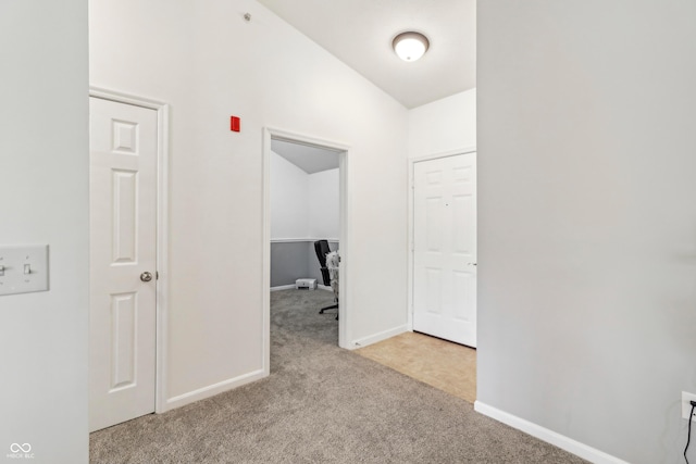8910 Hunters Creek Dr Unit 207, Indianapolis, IN 46227 - hall featuring carpet flooring, lofted ceiling, and baseboards