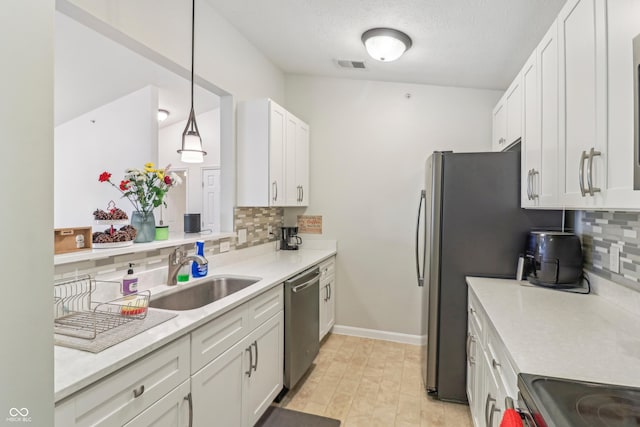 8910 Hunters Creek Dr Unit 207, Indianapolis, IN 46227 - kitchen with a sink, stainless steel appliances, decorative backsplash, white cabinetry, and a textured ceiling