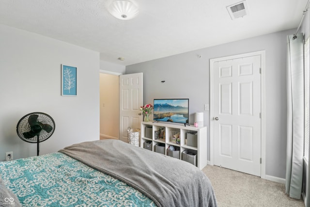 8910 Hunters Creek Dr Unit 207, Indianapolis, IN 46227 - bedroom with baseboards and light colored carpet