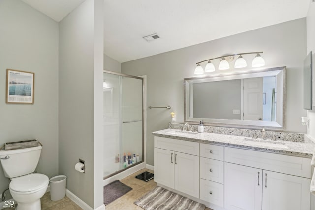 8910 Hunters Creek Dr Unit 207, Indianapolis, IN 46227 - bathroom featuring a stall shower, toilet, double vanity, baseboards, and tile patterned flooring
