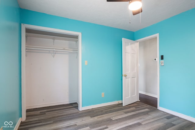 522 E County Road 1000 S, Clayton, IN 46118 - unfurnished bedroom featuring wood finished floors, a closet, baseboards, and ceiling fan