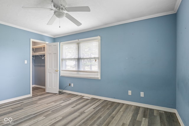 522 E County Road 1000 S, Clayton, IN 46118 - unfurnished bedroom with wood finished floors, baseboards, ornamental molding, a closet, and ceiling fan