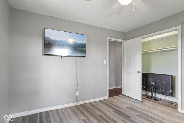 522 E County Road 1000 S, Clayton, IN 46118 - unfurnished bedroom featuring wood finished floors, baseboards, a closet, and a ceiling fan
