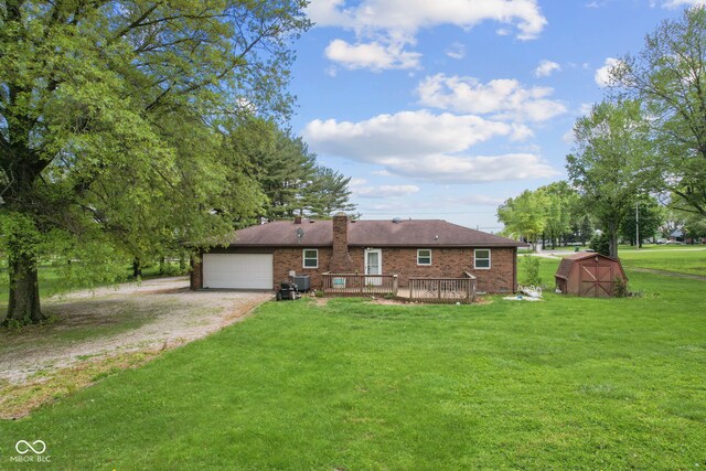 522 E County Road 1000 S, Clayton, IN 46118 - view of front of home with driveway, a shed, a front yard, a deck, and an attached garage