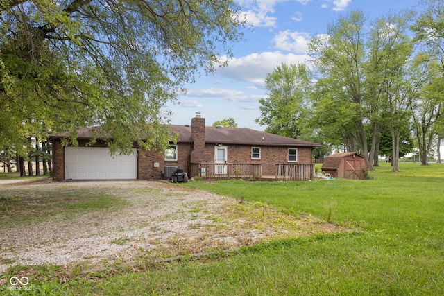 522 E County Road 1000 S, Clayton, IN 46118 - back of property with a shed, a yard, driveway, a chimney, and an attached garage