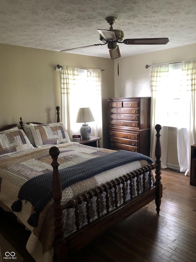 21749 Oak Ridge Rd, Sheridan, IN 46069 - bedroom featuring multiple windows, wood-type flooring, ceiling fan, and a textured ceiling