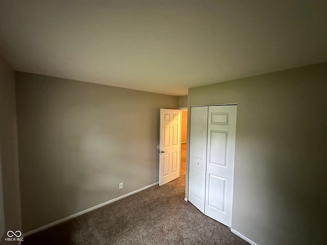 3742 N Wittfield St, Indianapolis, IN 46235 - unfurnished bedroom with dark carpet, baseboards, and a closet
