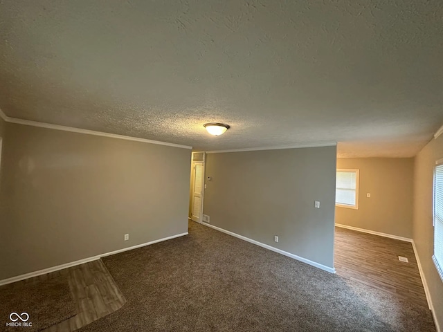 3742 N Wittfield St, Indianapolis, IN 46235 - unfurnished room featuring a textured ceiling, baseboards, dark colored carpet, and crown molding