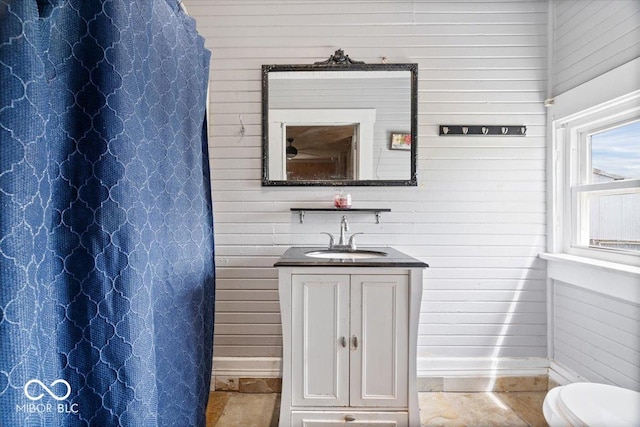 671 W 350 N, Shelbyville, IN 46176 - full bathroom featuring baseboards, wood walls, vanity, a shower with curtain, and toilet