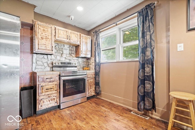 671 W 350 N, Shelbyville, IN 46176 - kitchen featuring electric stove, tile counters, baseboards, and light wood-style flooring